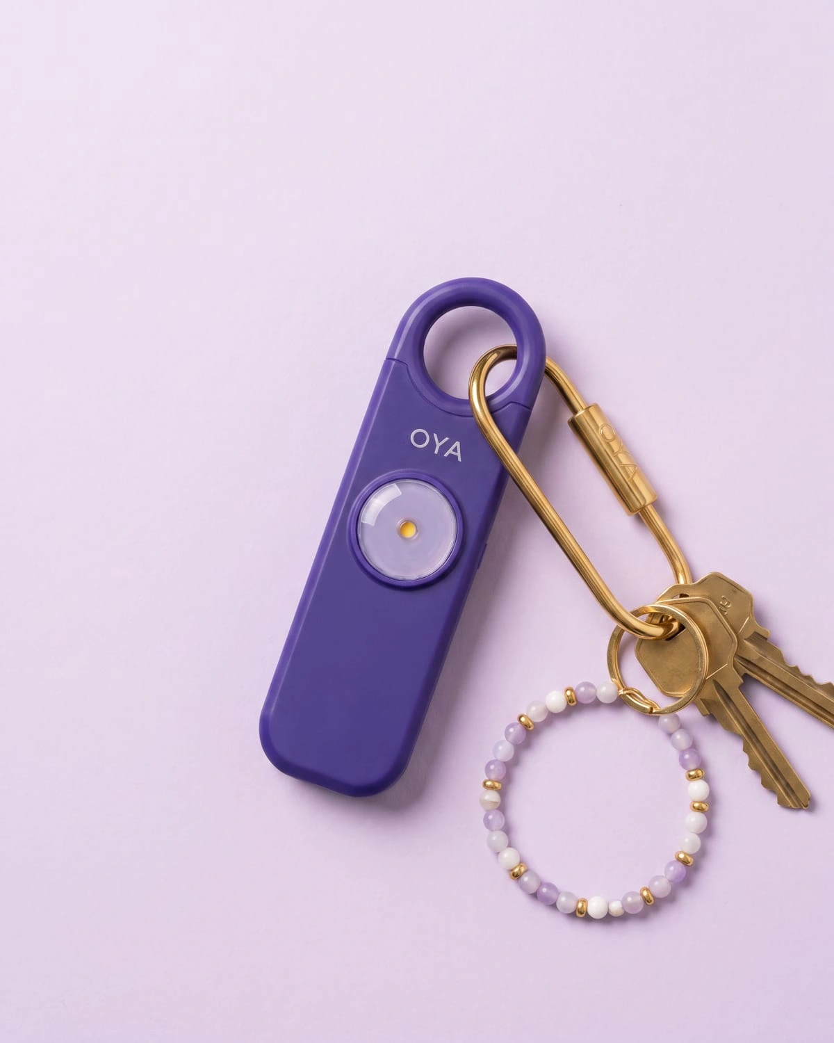 OYA Lilac Pearl, Anti-agression, sirène 130 dB et lampe, posée à plat avec des clés