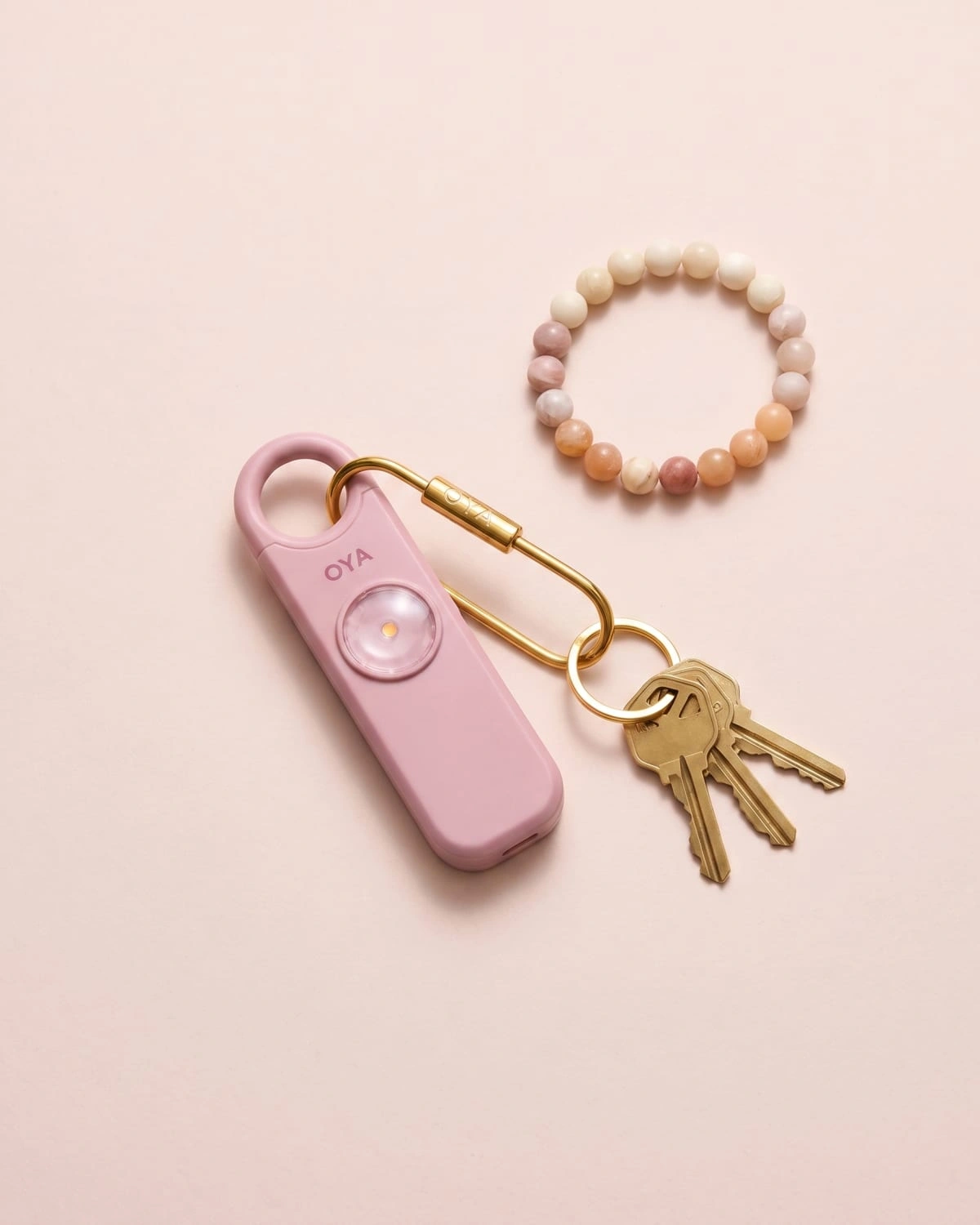 OYA Persian Pink, Anti-agression, sirène 130 dB et lampe, posée à plat avec des clés